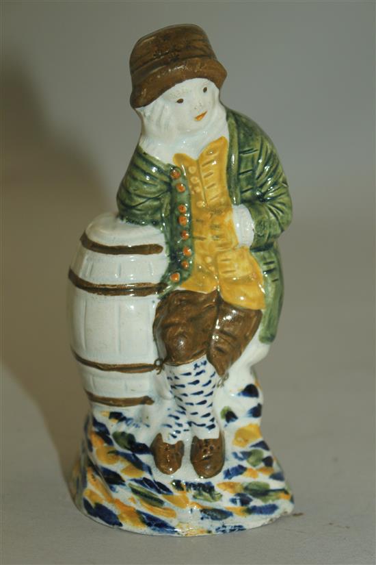 A Prattware figure of a young boy leaning on a barrel, late 18th century, 11.8cm